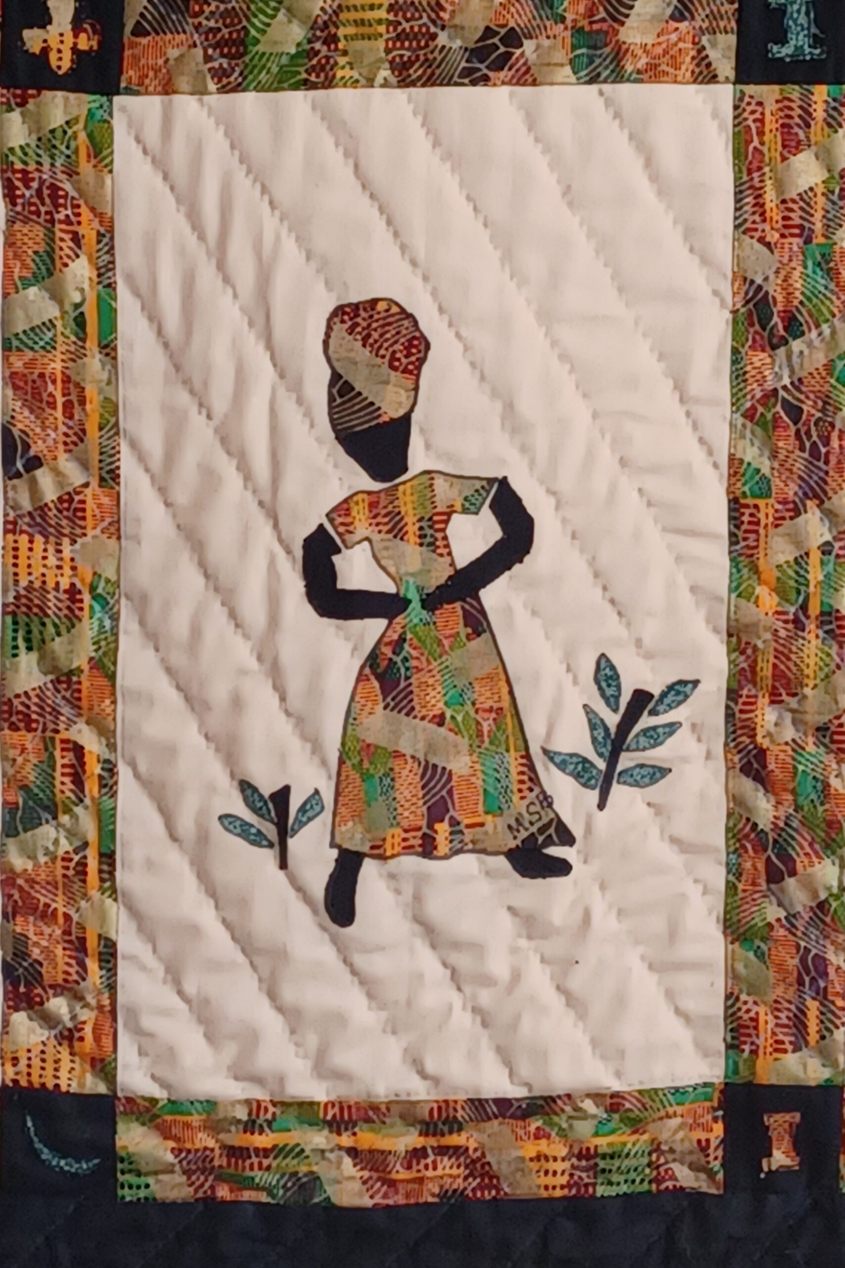 Quilted artwork titled 'Faith' from the Dancing Ladies Collection, featuring a silhouette of a woman gracefully poised with a flowing garment, representing belief and resilience.