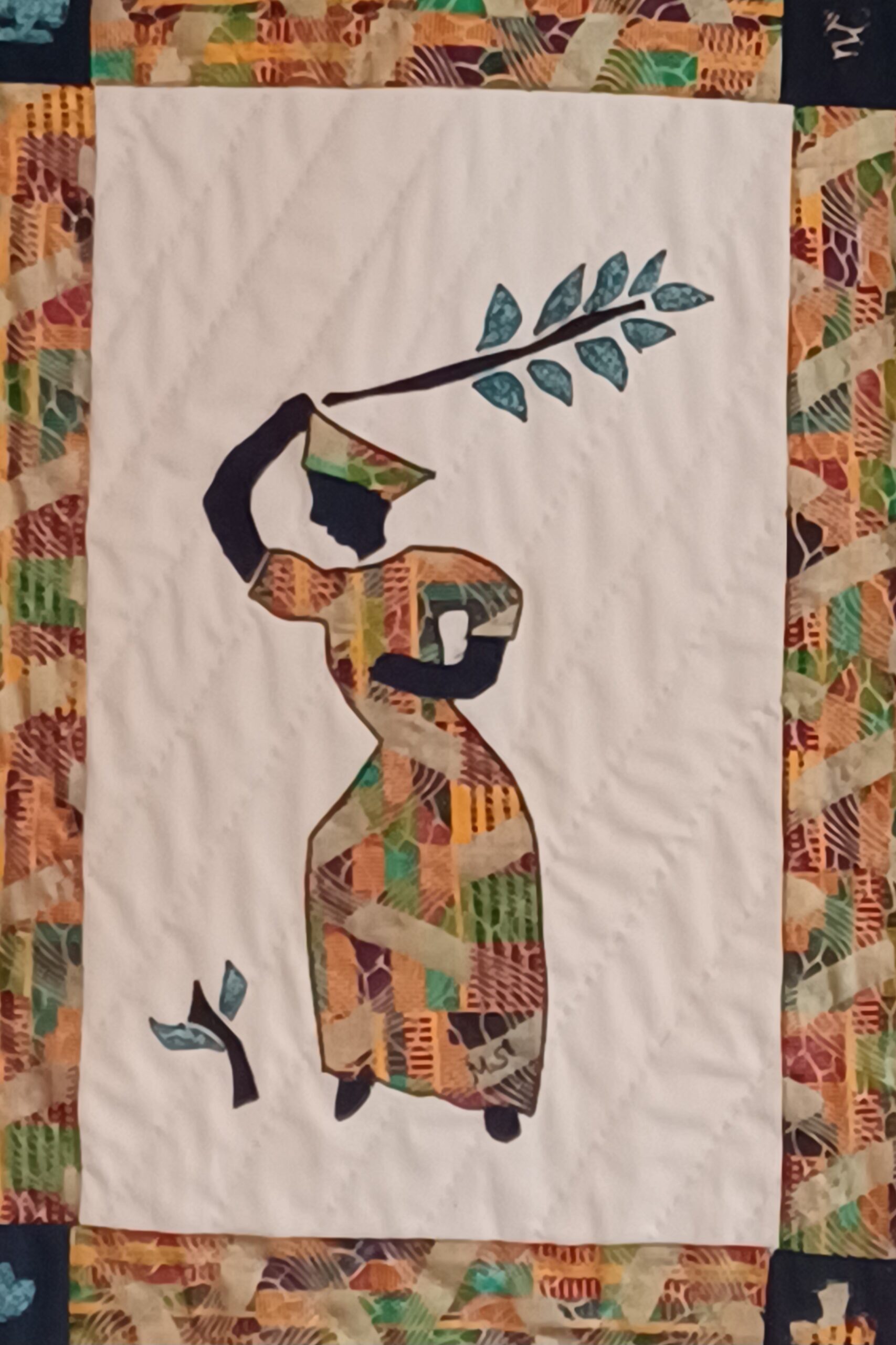 'Strength' from the Dancing Ladies Collection – a quilted fiber art piece featuring a poised figure, symbolizing resilience and determination.