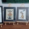 Framed fiber art by Marjorie Barner of StitchIt Designs, showcasing vibrant quilted silhouettes of dancing women in traditional African-inspired attire.