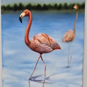 A striking pink flamingo wading gracefully through calm blue waters, capturing the elegance and vibrancy of coastal wildlife.