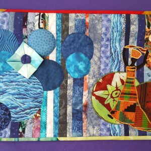 Fiber art quilt with blue and gray strip patterns, round appliqué pieces, and African-inspired designs.