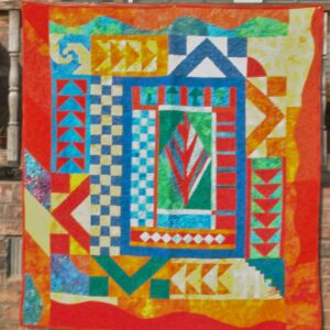 Brightly colored fiber art quilt with geometric blocks, checkerboard squares, and a bold central red motif.