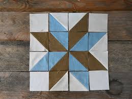 Lemoyne Star quilt blocks featuring eight-point star patterns pieced from diamond shapes in coordinated fabrics.