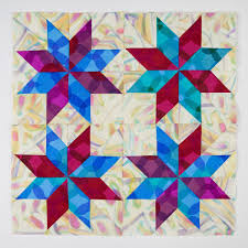 Lemoyne Star quilt blocks featuring eight-point star patterns pieced from diamond shapes in coordinated fabrics.