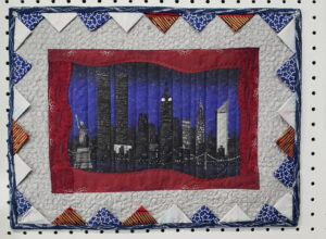 Quilts featuring prairie point binding with folded fabric triangles creating a textured, dimensional edge around the border.