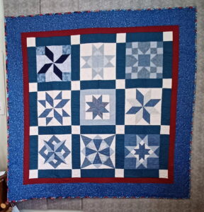 Star Crazy quilt blocks featuring multiple star designs arranged in a sampler layout with coordinated fabrics.